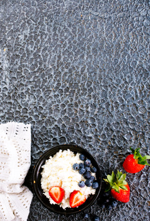 Cottage cheese with strawberry and blueberry, fresh berries, healthy breakfast concept, top viewの写真素材