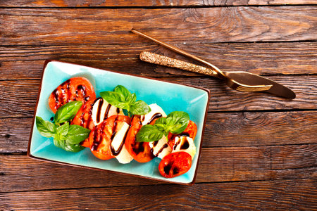 Caprese salad with mozzarella cheese, tomatoes and basil. Typical Italian cuisineの写真素材