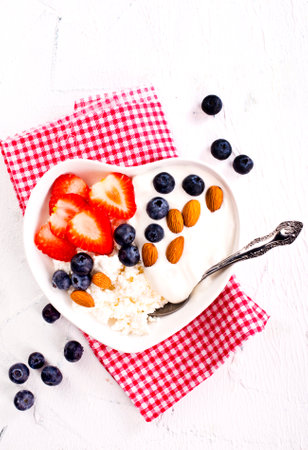 Cottage cheese with strawberry and blueberry, fresh berries, healthy breakfast concept, top viewの写真素材