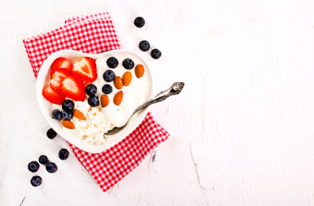Cottage cheese with strawberry and blueberry, fresh berries, healthy breakfast concept, top viewの写真素材