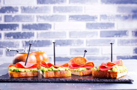 Whole grain bread sandwiches with prosciutto and avocado. Clean eating, healthy breakfast. Top view, flat layの写真素材