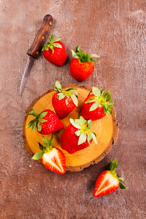 Fresh strawberries on wooden board on a tableの写真素材