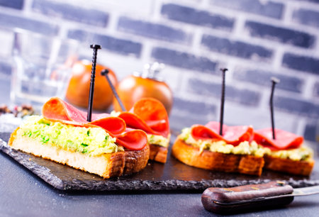 Whole grain bread sandwiches with prosciutto and avocado. Clean eating, healthy breakfast. Top view, flat layの写真素材