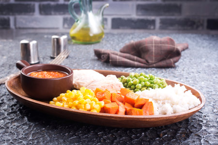 lunch box with rice, carrot, corn and chicken meatの写真素材