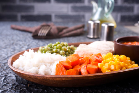 lunch box with rice, carrot, corn and chicken meatの写真素材