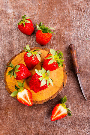 Fresh strawberries on wooden board on a tableの写真素材