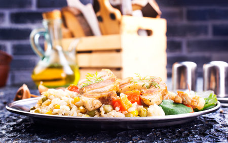 Meat fried with vegetables, a side dish of bulgur, top viewの写真素材