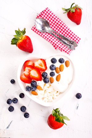 Cottage cheese with strawberry and blueberry, fresh berries, healthy breakfast concept, top viewの写真素材