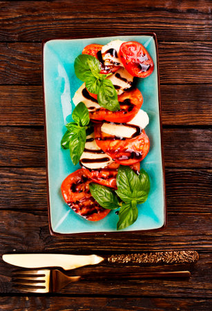 Caprese salad with mozzarella cheese, tomatoes and basil. Typical Italian cuisineの写真素材