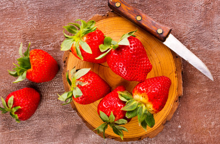 Fresh strawberries on wooden board on a tableの写真素材