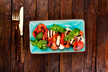 Caprese salad with mozzarella cheese, tomatoes and basil. Typical Italian cuisineの写真素材