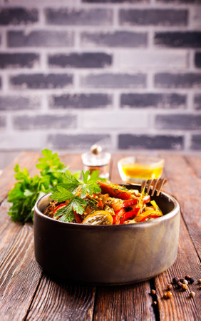 Fresh colorful spring vegetable salad with cherry tomatoes and sweet peppers in the bowl.の写真素材