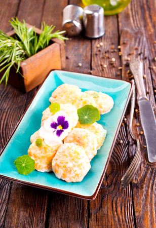 fish cutlets on blue plateの写真素材