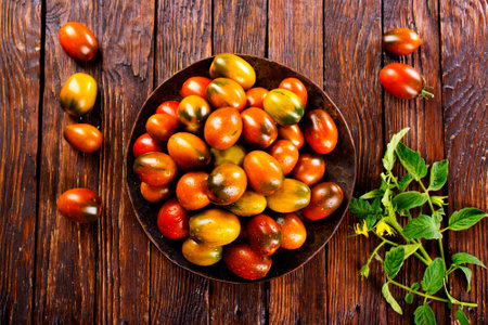 The harvest of assorted tomatoes, banner. Colorful organic tomatoes on a large dish. Tomatoes different varieties. Top viewの写真素材