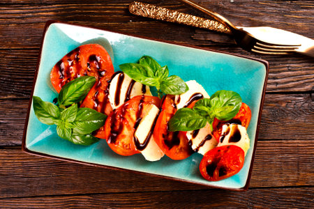 Caprese salad with mozzarella cheese, tomatoes and basil. Typical Italian cuisineの写真素材