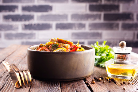 Fresh colorful spring vegetable salad with cherry tomatoes and sweet peppers in the bowl.の写真素材