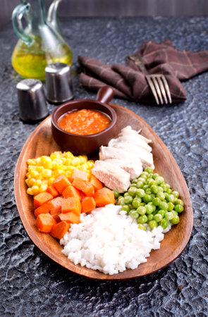 lunch box with rice, carrot, corn and chicken meatの写真素材