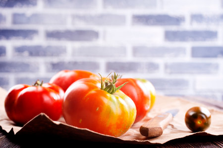 fresh tomato on paper on a tableの写真素材