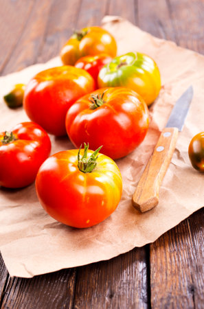 fresh tomato on paper on a tableの写真素材