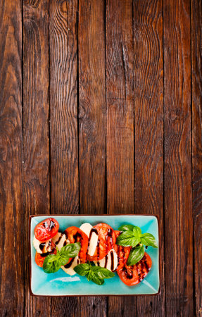 Caprese salad with mozzarella cheese, tomatoes and basil. Typical Italian cuisineの写真素材