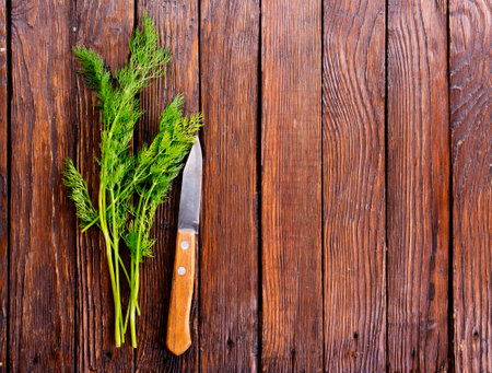 Chopped fresh dill on a cutting Board and a bunch of dill preparation for freezing serving size organic healthy thing natural product portion on a wooden table. Top view,の写真素材