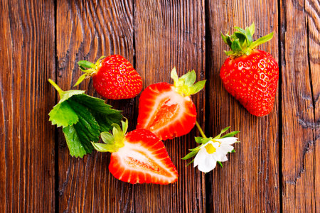 Fresh ripe organic strawberry on wooden tableの写真素材