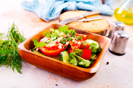 tomato, cucumber and onion salad in wooden bowlの写真素材