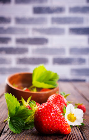 Fresh ripe organic strawberry on wooden tableの写真素材