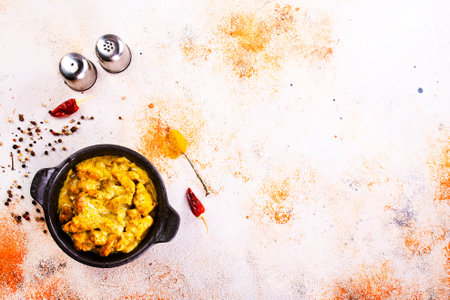 Chicken curry or masala, Kerala style chicken curry using fried coconut in traditional way and arranged in a black ceramic vesselの写真素材