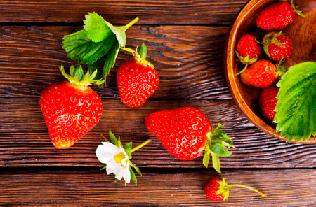 Fresh ripe organic strawberry on wooden tableの写真素材