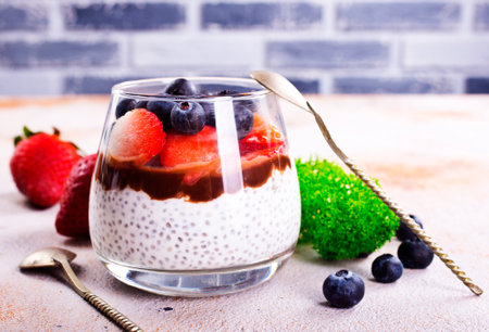 Healthy breakfast, desert, with chia seed pudding, cream, raspberry jam and fresh berriesの写真素材