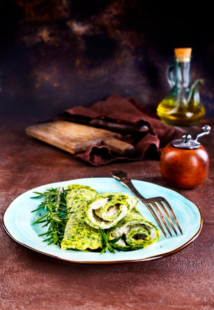 Rolls of spinach pancakes with cheese and fried shrimpsの写真素材