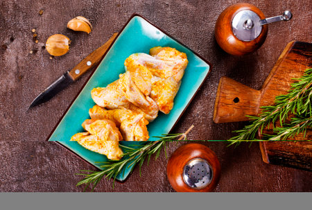 Marinated chicken wings wth rosemary and garlicの写真素材