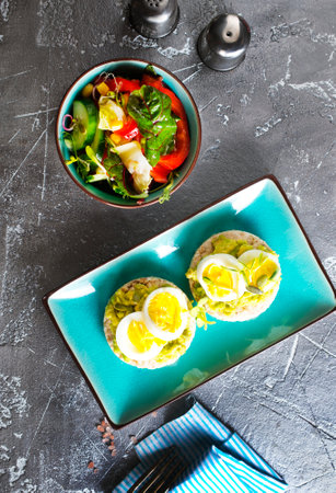 grain toast with avocado, white cheese and boiled egg, diet foodの写真素材