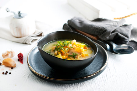 Pea soup with pieces of bacon and parsley in a bowlの写真素材