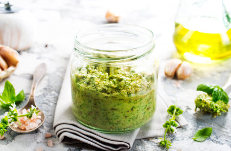 pesto sauce in glass jarの写真素材