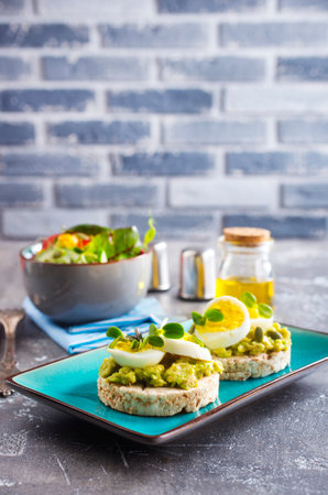grain toast with avocado, white cheese and boiled egg, diet foodの写真素材