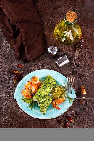 Rolls of spinach pancakes with cheese and fried shrimpsの写真素材