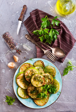 fried zucchini in oil, with salt and garlicの写真素材