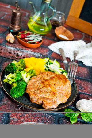 steak with onions and cherry tomatoesの写真素材