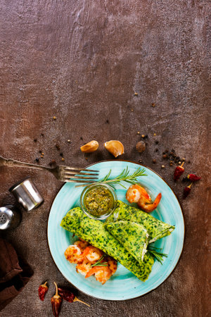 Rolls of spinach pancakes with cheese and fried shrimpsの写真素材