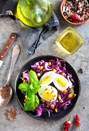 Cabbage salad with corn and boiled egg on plateの写真素材