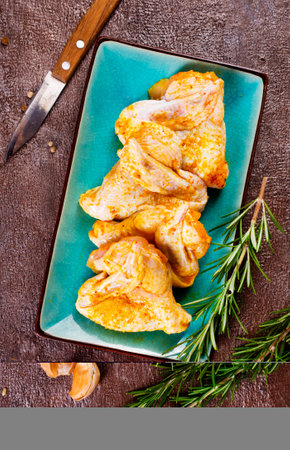 Marinated chicken wings wth rosemary and garlicの写真素材
