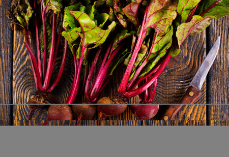 fresh beets on cutting board, set on wooden table