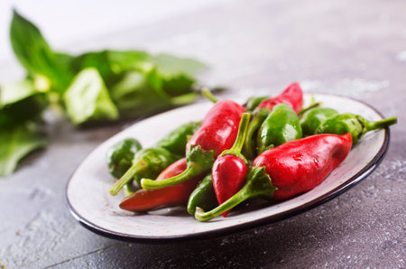 fresh chilli peppers over gray backgroundの写真素材