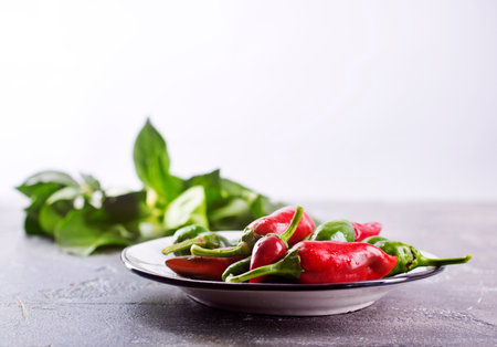 fresh chilli peppers over gray backgroundの写真素材