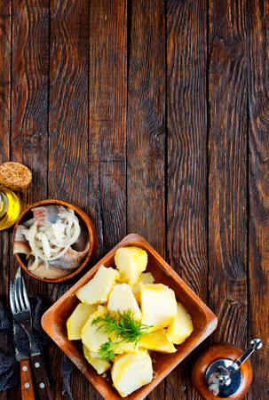 Salted Fish with Boiled Potato and Pickled Onions on plateの写真素材