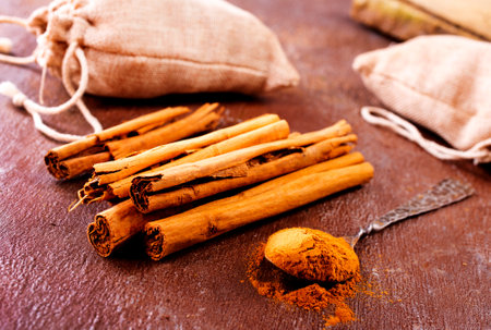 Cinnamon sticks on a wooden background. Cinnamon spice in a spoon and bowl. Ceylon cinnamon.の写真素材