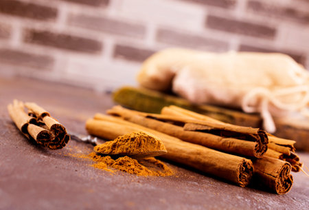 Cinnamon sticks on a wooden background. Cinnamon spice in a spoon and bowl. Ceylon cinnamon.の写真素材