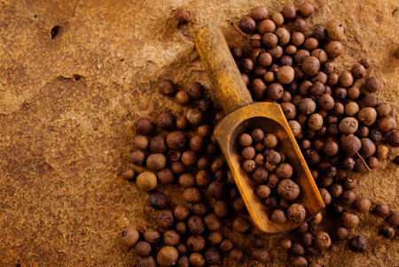 Black pepper in bow on wooden table. Pile of ground black pepper.の写真素材